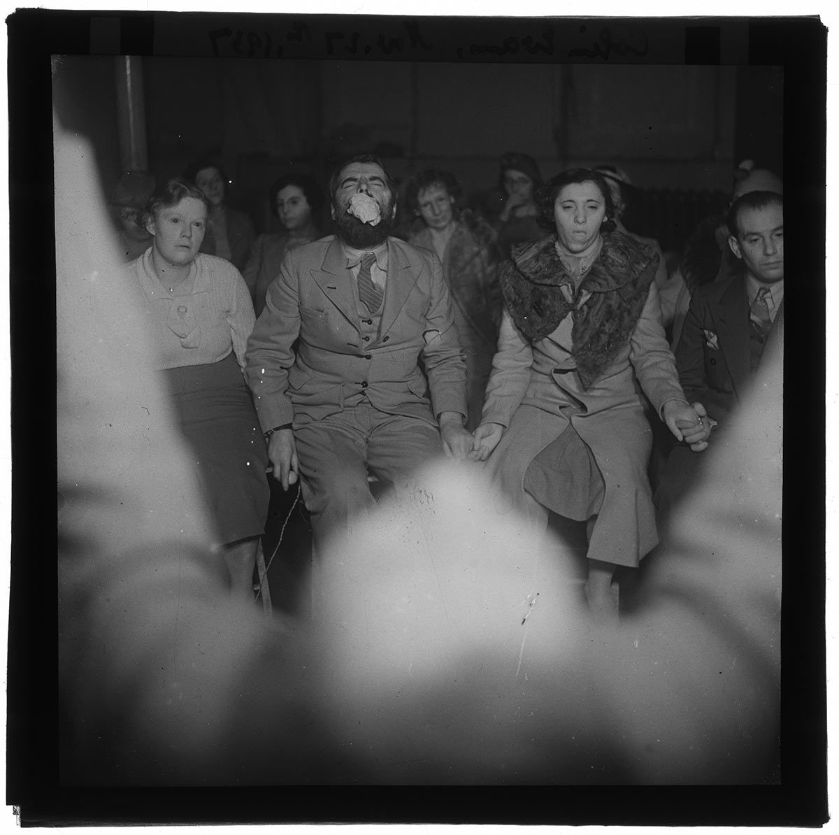 Fodor plates_017 - black and white photo of people holding hands in chairs, possibly praying