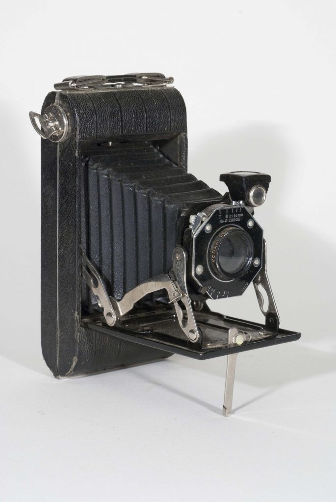 Kodak Jr. Six 20, 1935-1937. Vertical, open, front view, angled to right.