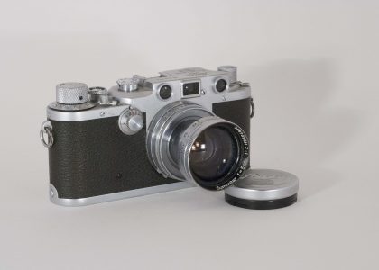 Leica IIIC, 1940-1946. Front view, angled to right, lens fully extended.