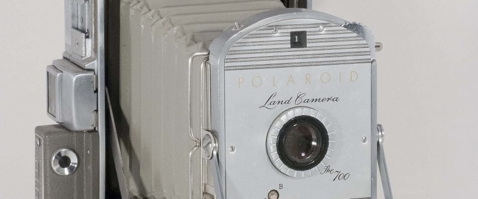 Polaroid 700, 1955-1957. Open, vertical, front view, angled to right.