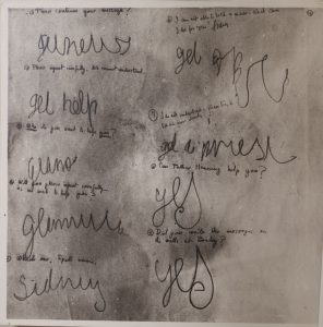 A photograph of the planchette writing taken during the seances at Borley Rectory The question prompts are numbered in small handwriting, with the spirit answers in large cursive handwriting.