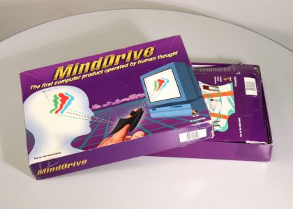 Slightly open, rectangular box. Lid of the box has a person's head and a finger pointing at a computer.