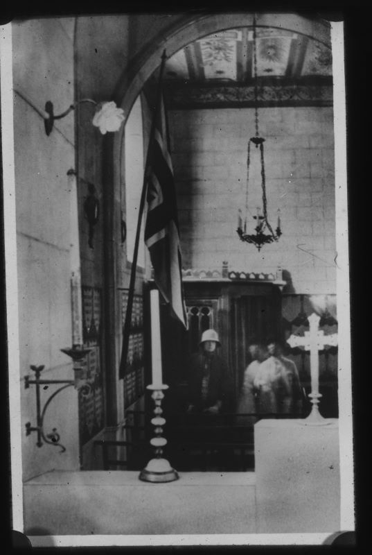 An image taken inside a church shows an apparition with a human form standing next to a person.