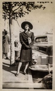 women standing next to car