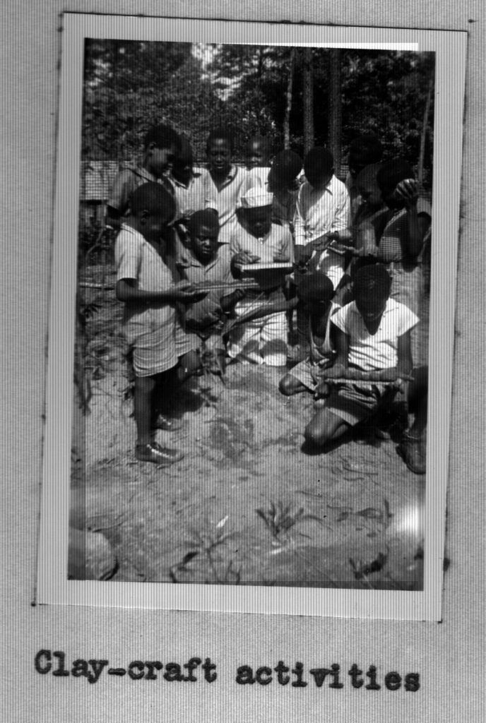 A group of children play with clay at Prince William Camp.