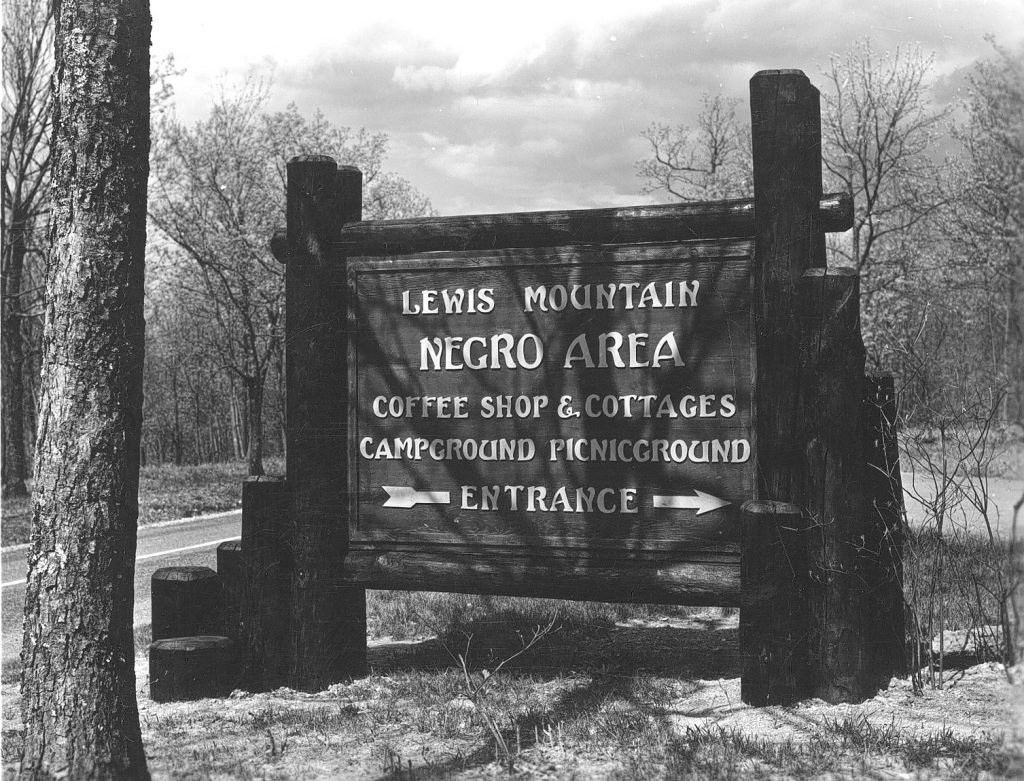 A wooded sign for "Lewis Mountain Negro Area"