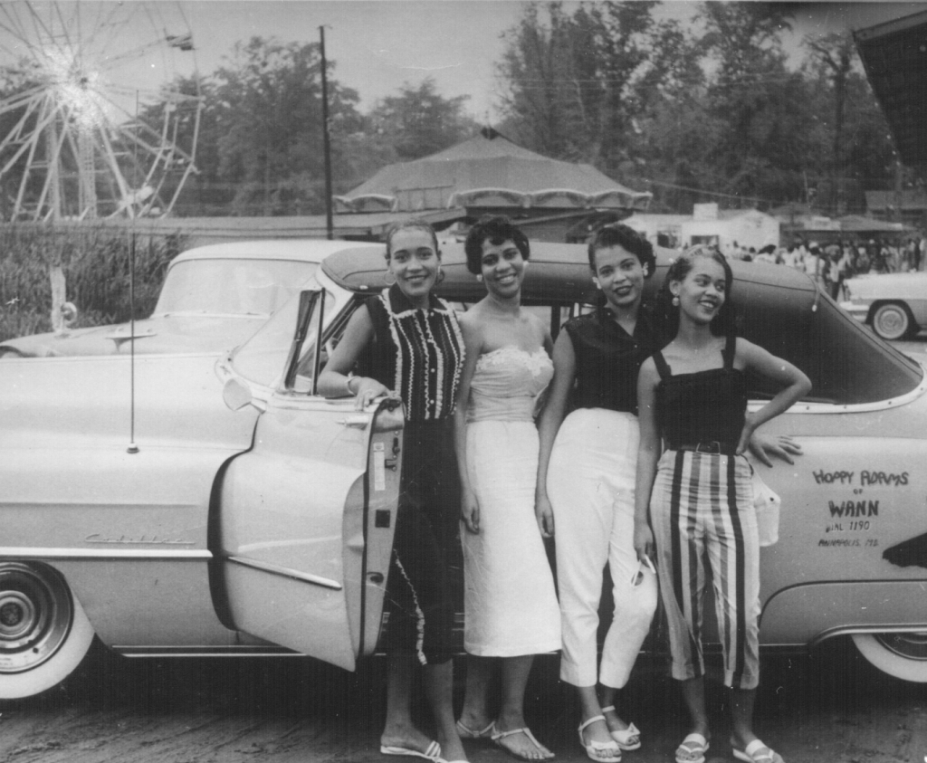 Four women standing in front of car at Carr's Beach