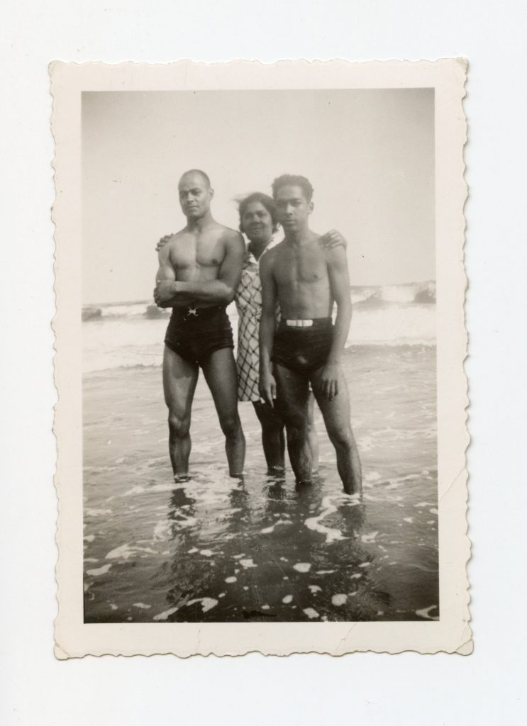 Three people posing in the water.