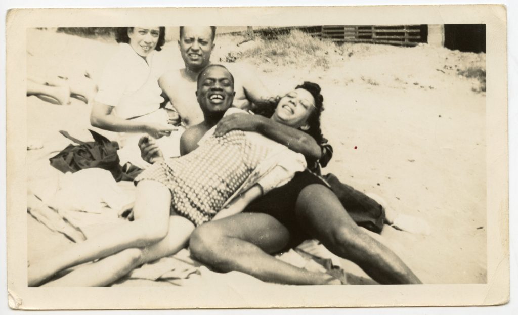 Group laying down on the beach.