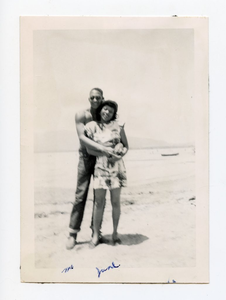 Couple posing on beach.