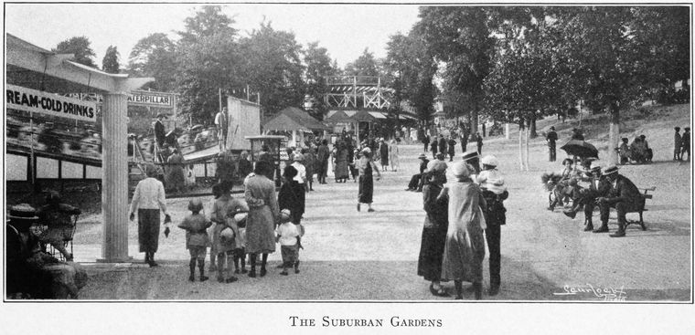 Black and white photo showing many people visiting the amusement park.