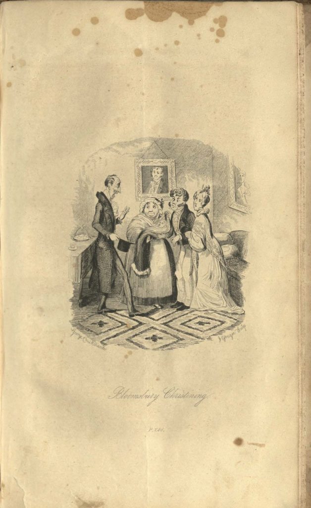 Four adults stand together in a front room. A woman in the middle holds a baby wrapped in blankets.