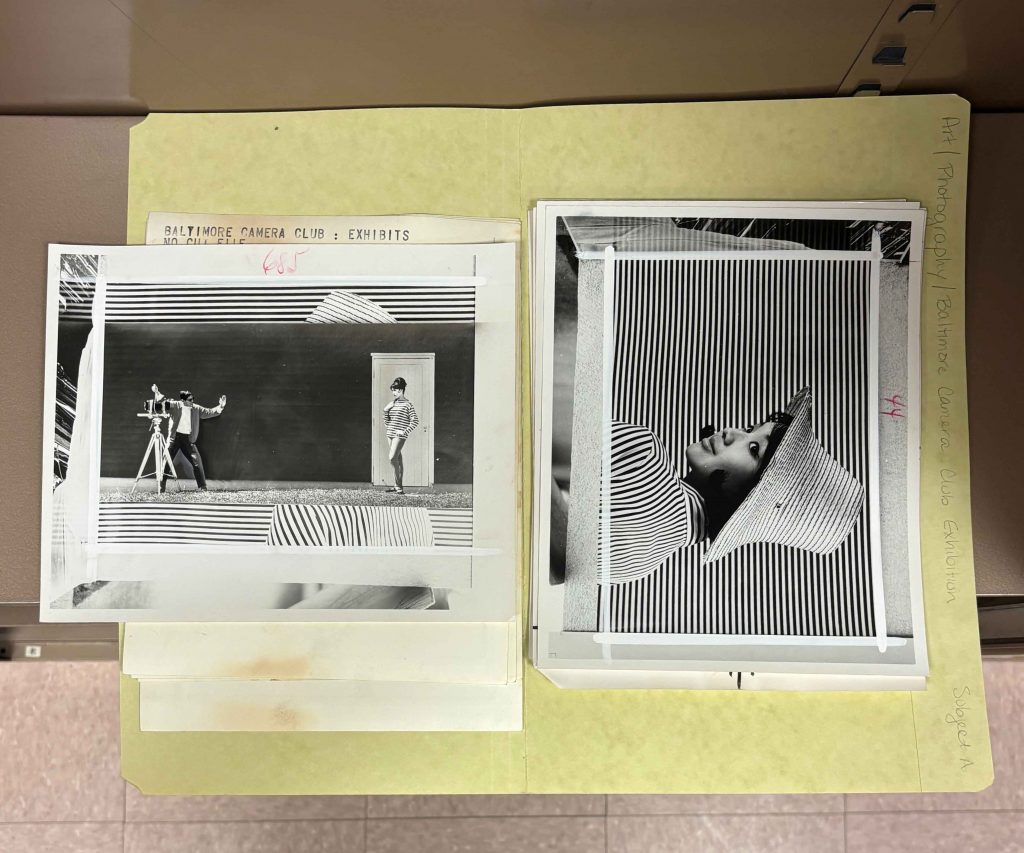 Black-and-white photographs in a folder